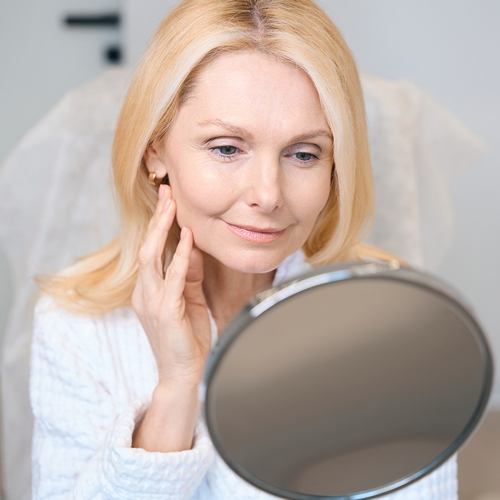 Beautiful Woman Looking In The Mirror